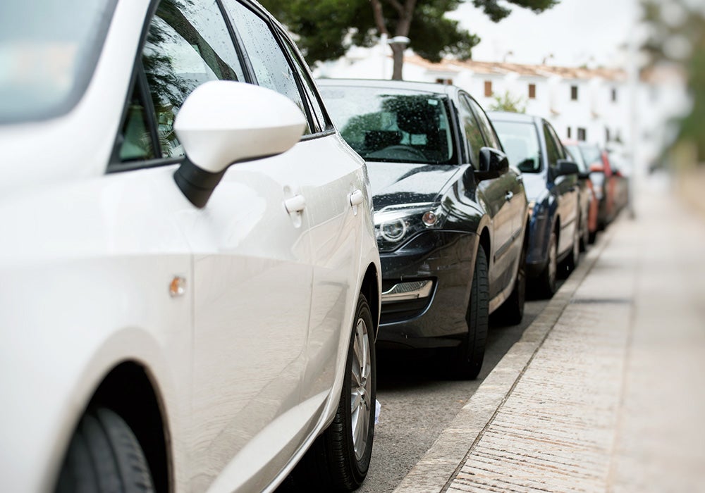 vehicles lined up next to sidewalk